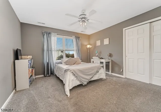 a living room with furniture a flat screen tv and gym equipment