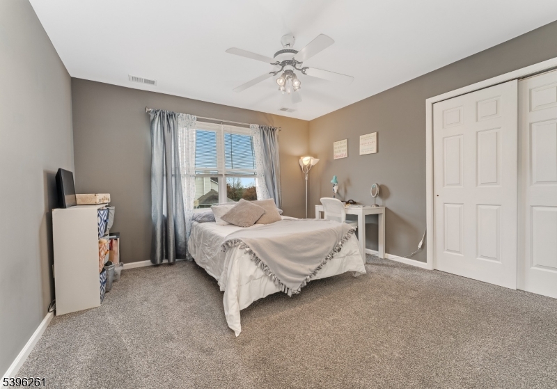 7 Maple Springs Road Pittstown, NJ 08867 - Photo 33 of 41 a bedroom with a bed and a chandelier