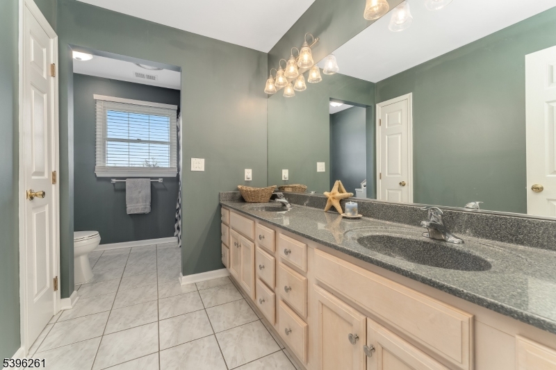 7 Maple Springs Road Pittstown, NJ 08867 - Photo 34 of 41 a spacious bathroom with a granite countertop sink a toilet a mirror and vanity