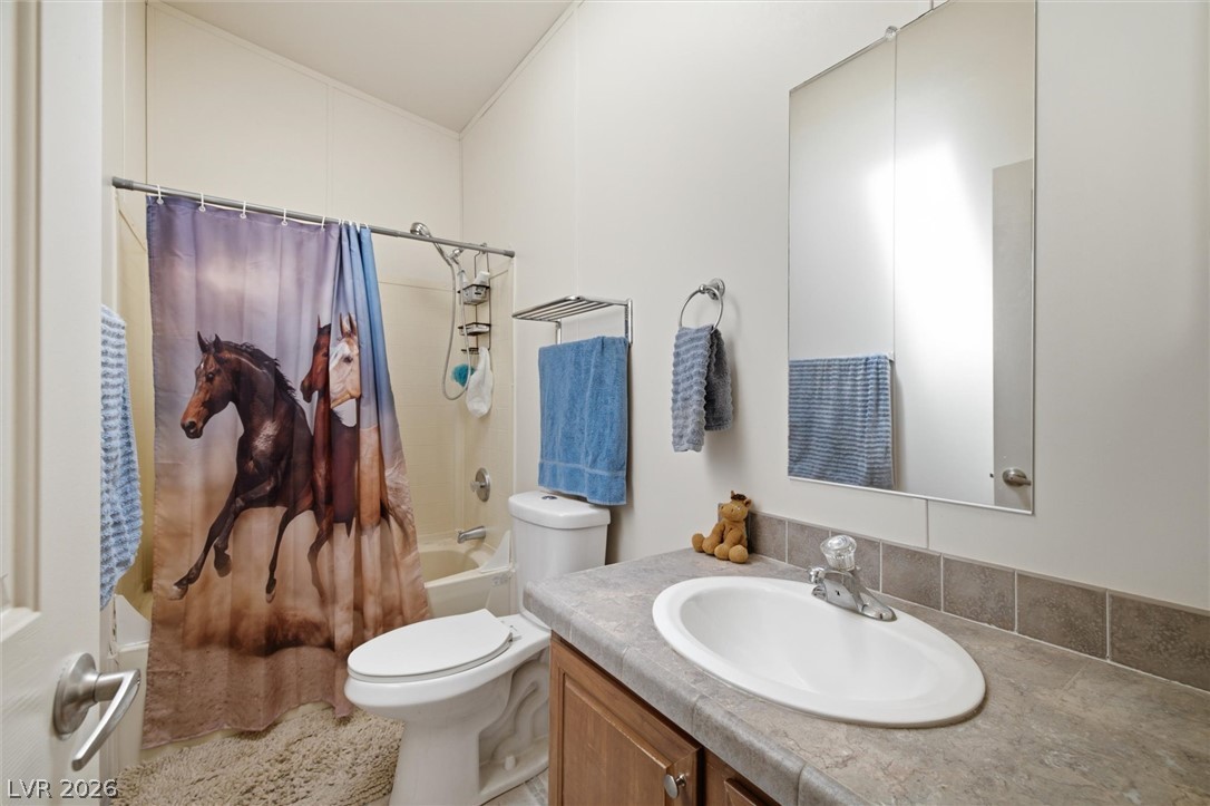 2380 West Simkins Road Pahrump, NV 89060 - Photo 25 of 38 A clean, functional bathroom features a neutral vanity area and a tub-shower combination.