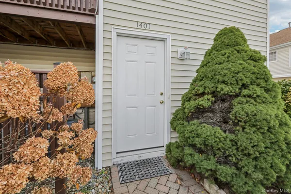 a yellow house with next to a yard