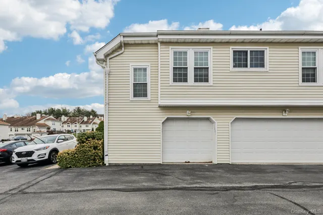 a view of a house with backyard and a garden