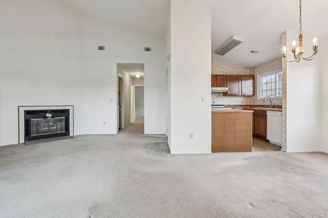 a view of a kitchen with a sink and a refrigerator
