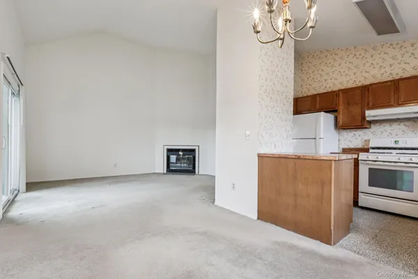 a view of a kitchen with wooden cabinet and a window