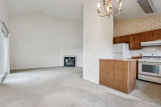 a view of a kitchen with wooden cabinet and a window