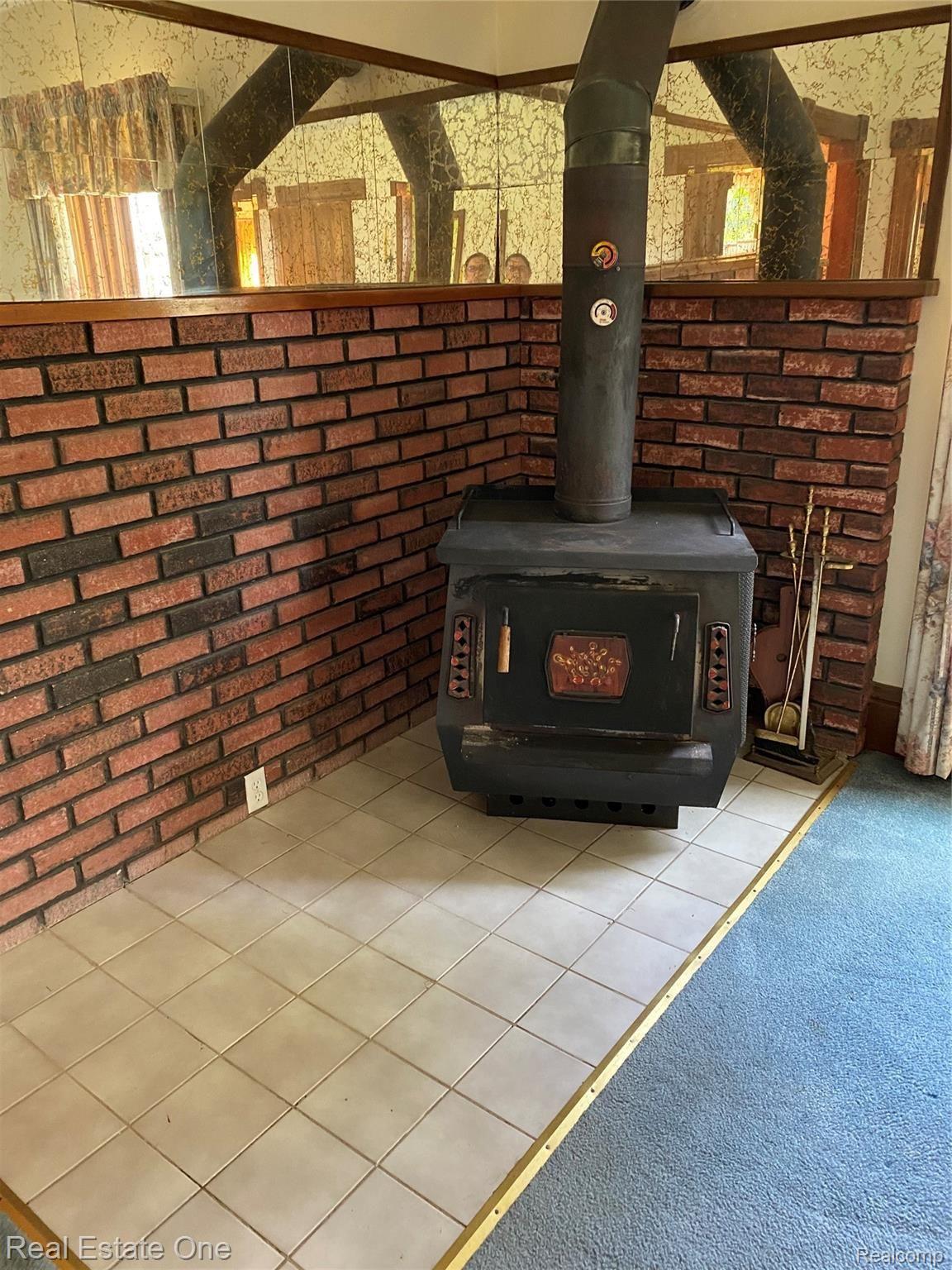7727 West Lovejoy Road Byron, MI 48418 - Photo 6 of 45 Living Room Wood Burning Stove.JPG