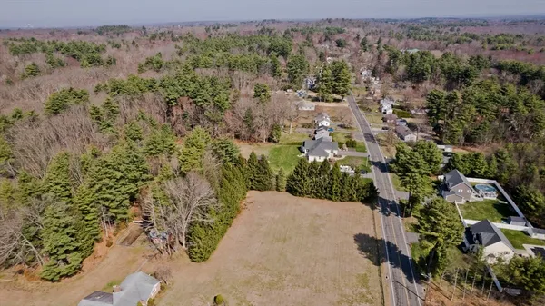 an aerial view of a house with a yard