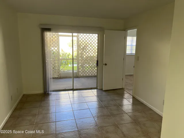 a view of a livingroom with an empty space and a window
