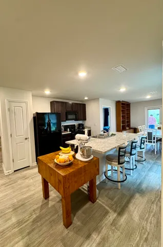 a living room with dining room and kitchen view
