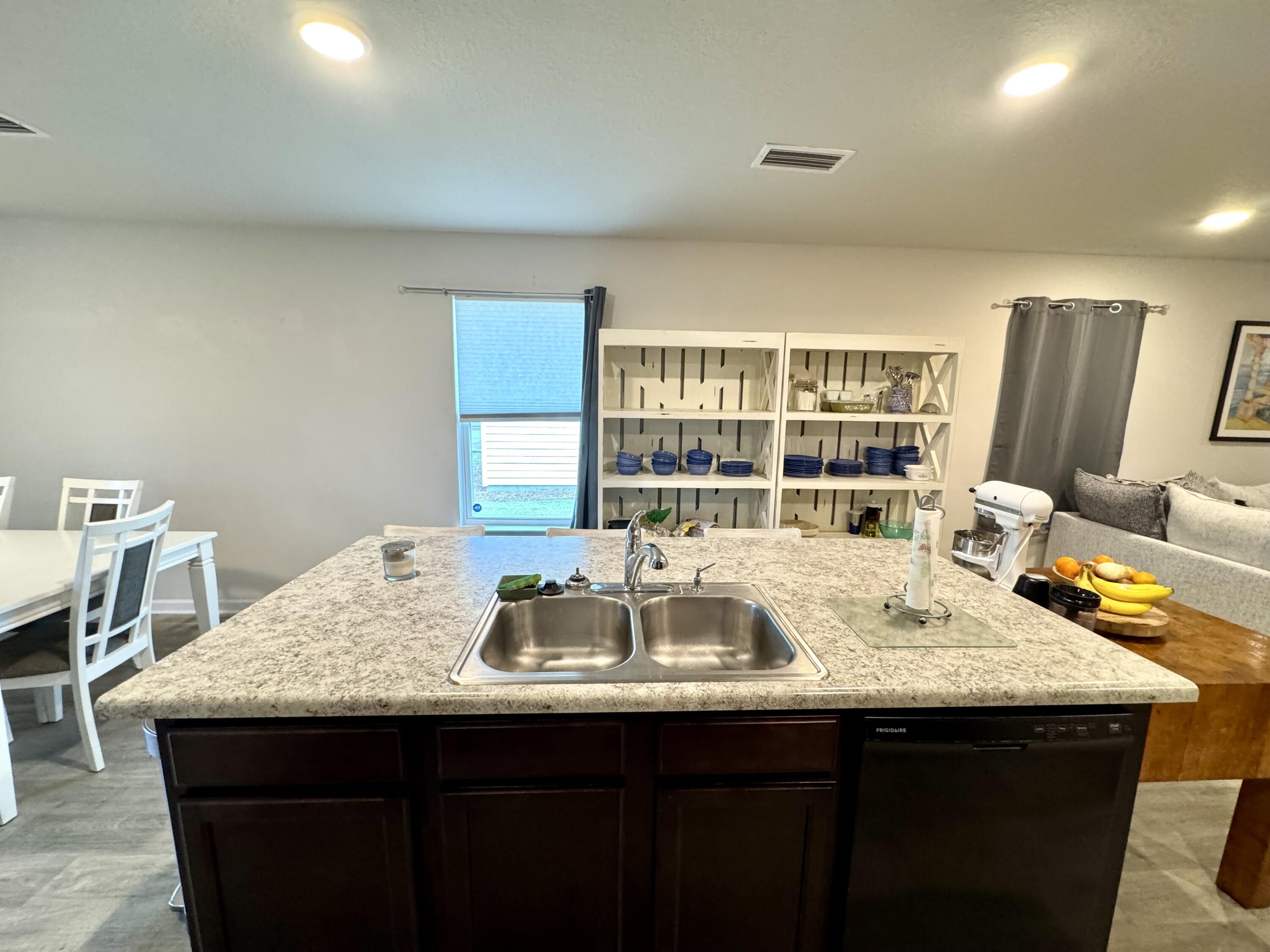 629 Earl Godwin Road Freeport, FL 32439 - Photo 12 of 36 a kitchen with granite countertop a sink and a wooden floor