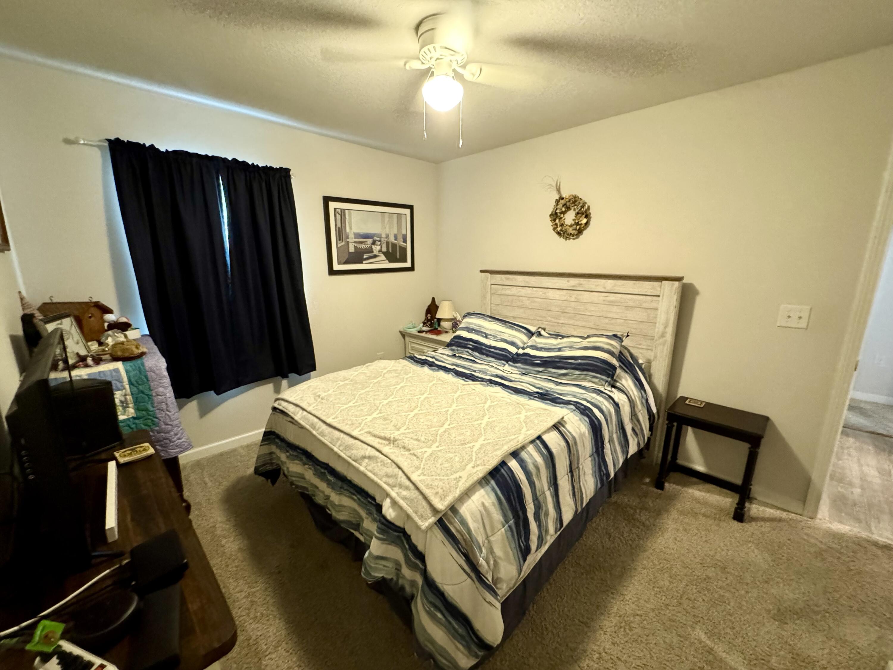 629 Earl Godwin Road Freeport, FL 32439 - Photo 14 of 36 a bedroom with a bed and a chandelier