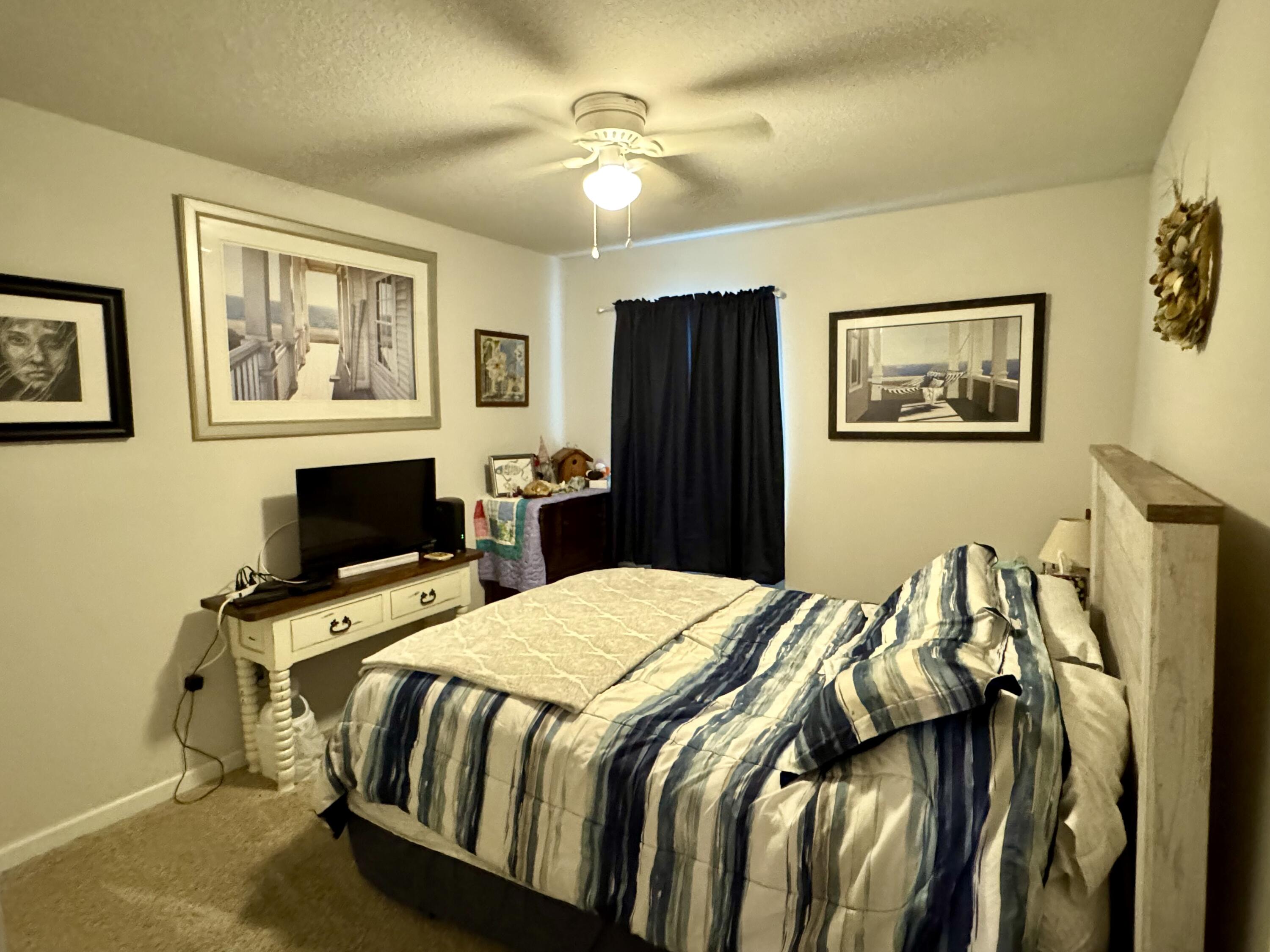 629 Earl Godwin Road Freeport, FL 32439 - Photo 15 of 36 a bedroom with a bed and wooden floor