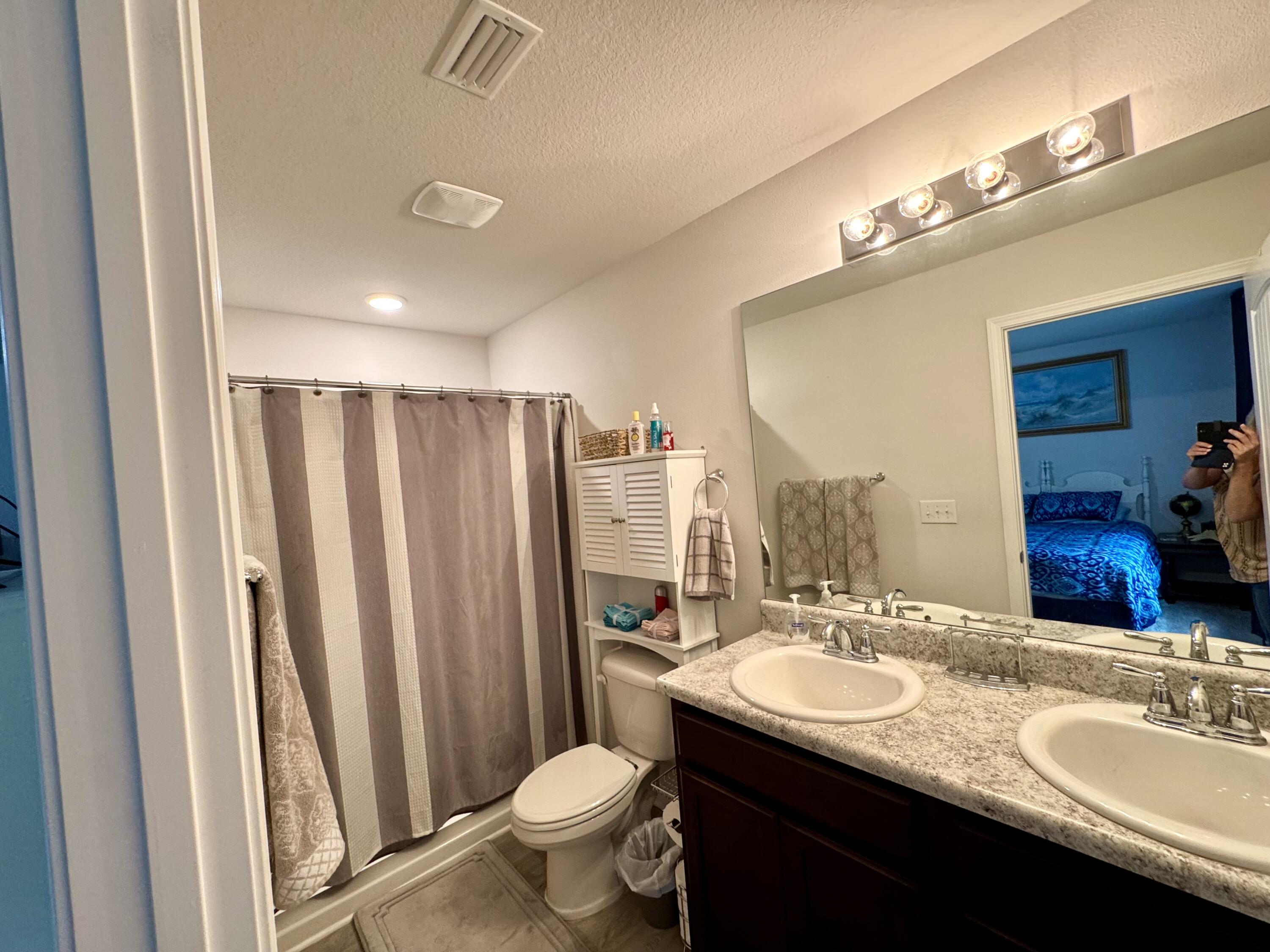 629 Earl Godwin Road Freeport, FL 32439 - Photo 21 of 36 a bathroom with a double vanity sink and a mirror