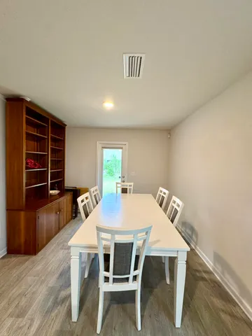 a dining area with furniture and a large window