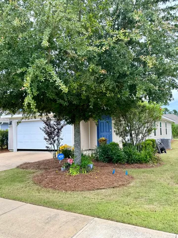 a front view of a house with garden