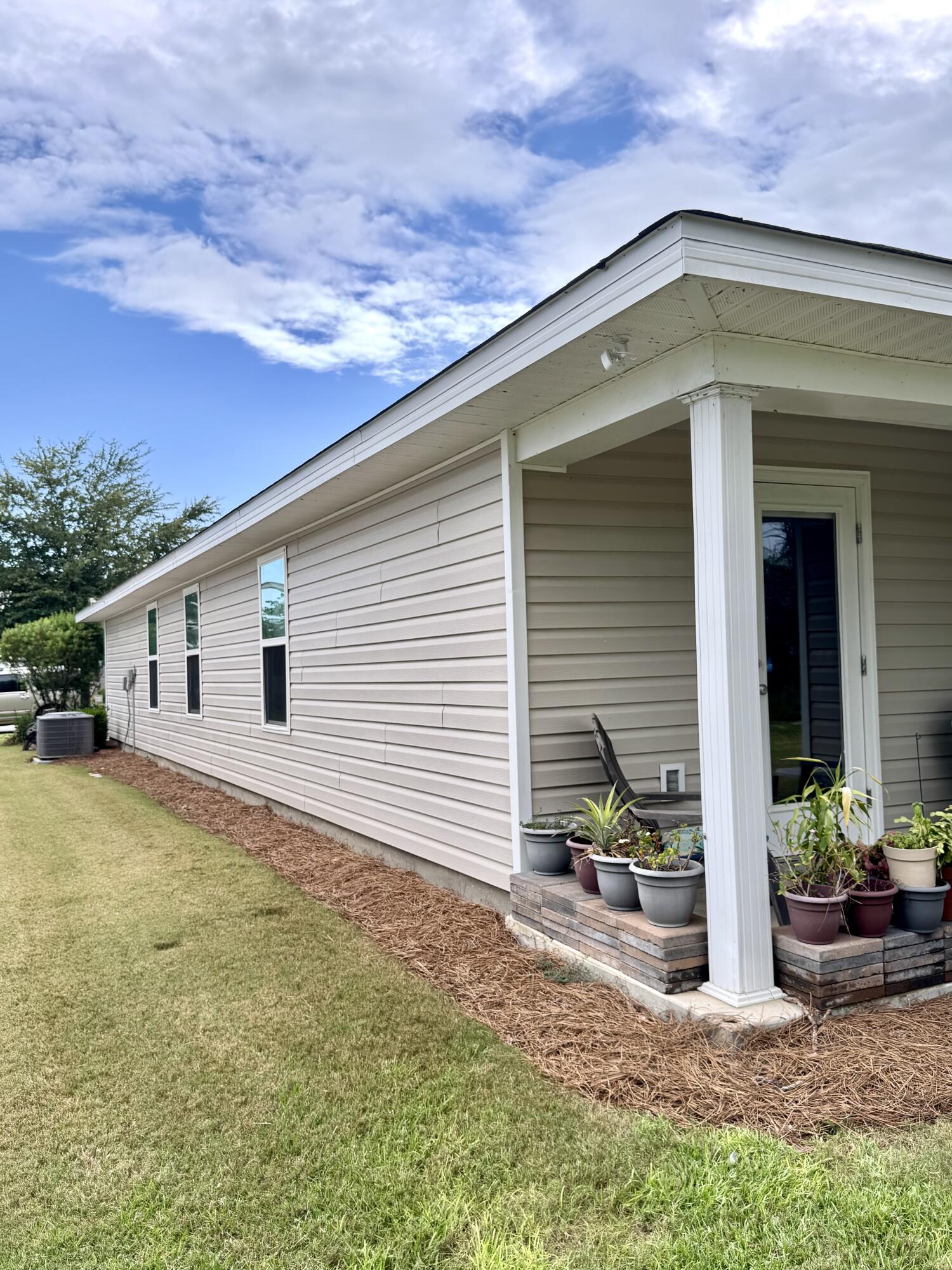 629 Earl Godwin Road Freeport, FL 32439 - Photo 4 of 36 a backyard of a house with table and chairs and potted plants