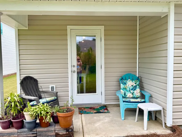 a view of a chair and table in back of the door