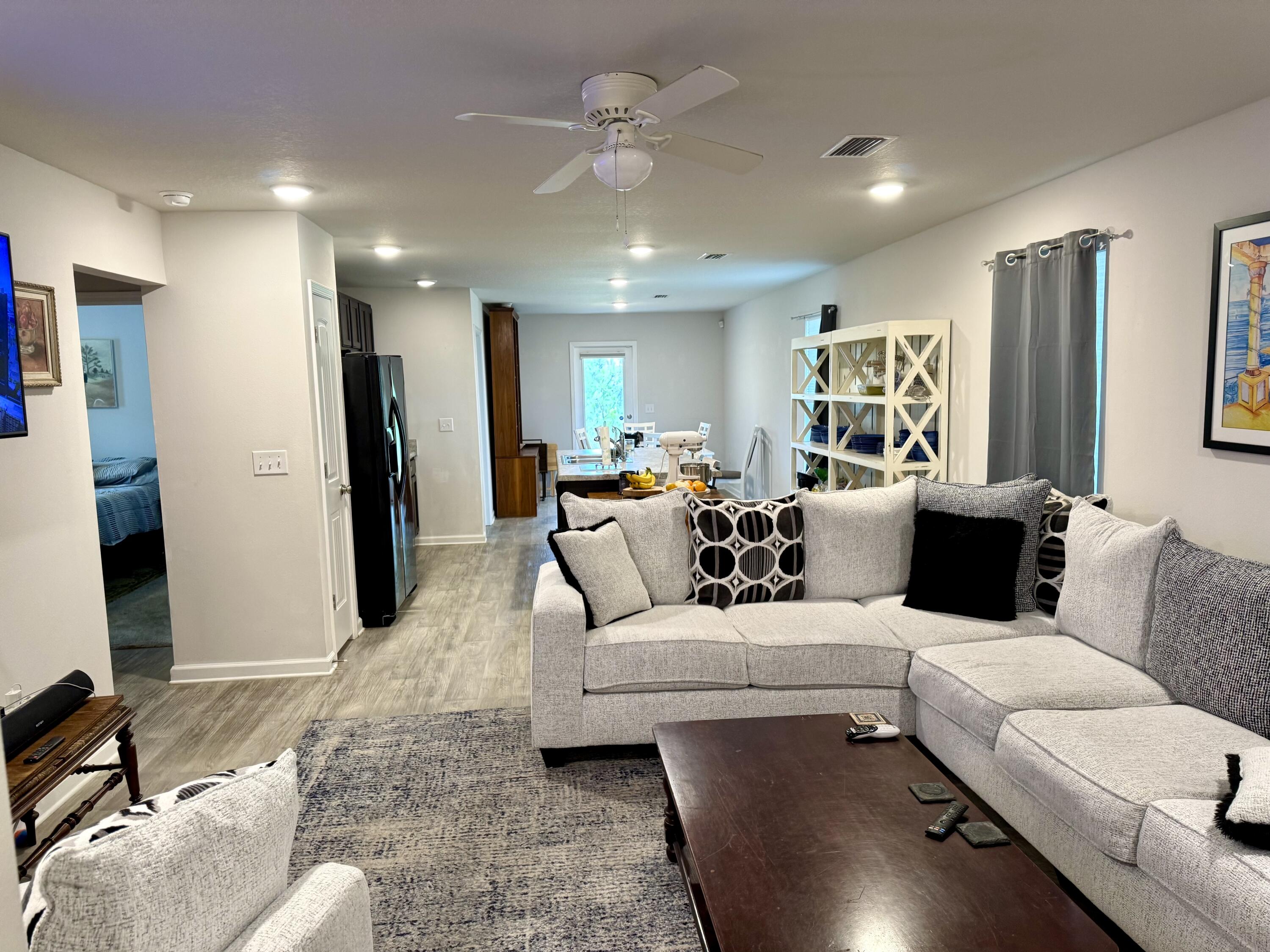 629 Earl Godwin Road Freeport, FL 32439 - Photo 9 of 36 a living room with furniture and a chandelier