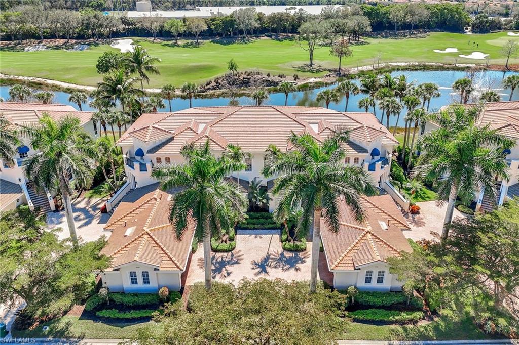 15516 Monterosso Lane, Unit 101 Naples, FL 34110 - Photo 1 of 31 Aerial view of a golf club and a nearby body of water