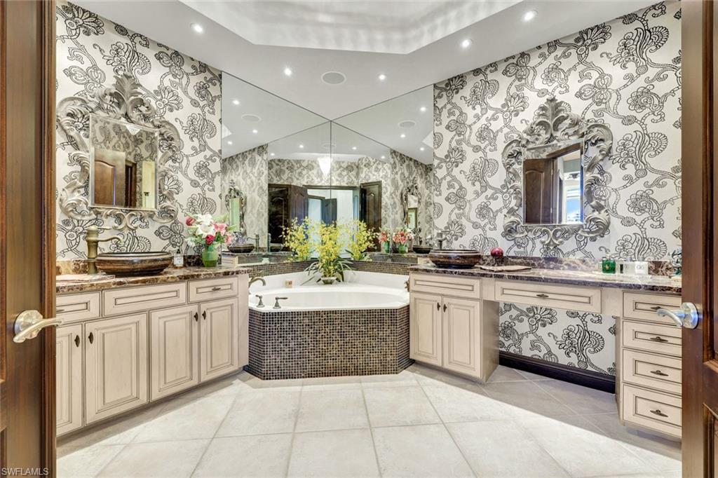 15516 Monterosso Lane, Unit 101 Naples, FL 34110 - Photo 17 of 31 Full bathroom with a garden tub, two vanities, light tile patterned floors, and recessed lighting