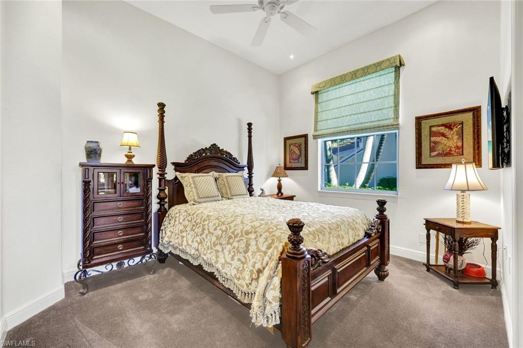 15516 Monterosso Lane, Unit 101 Naples, FL 34110 - Photo 20 of 31 Bedroom featuring a ceiling fan and dark carpet