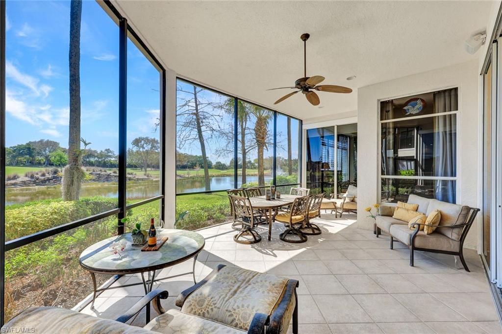 15516 Monterosso Lane, Unit 101 Naples, FL 34110 - Photo 23 of 31 Sunroom / solarium with expansive windows, tile patterned flooring, and a water view