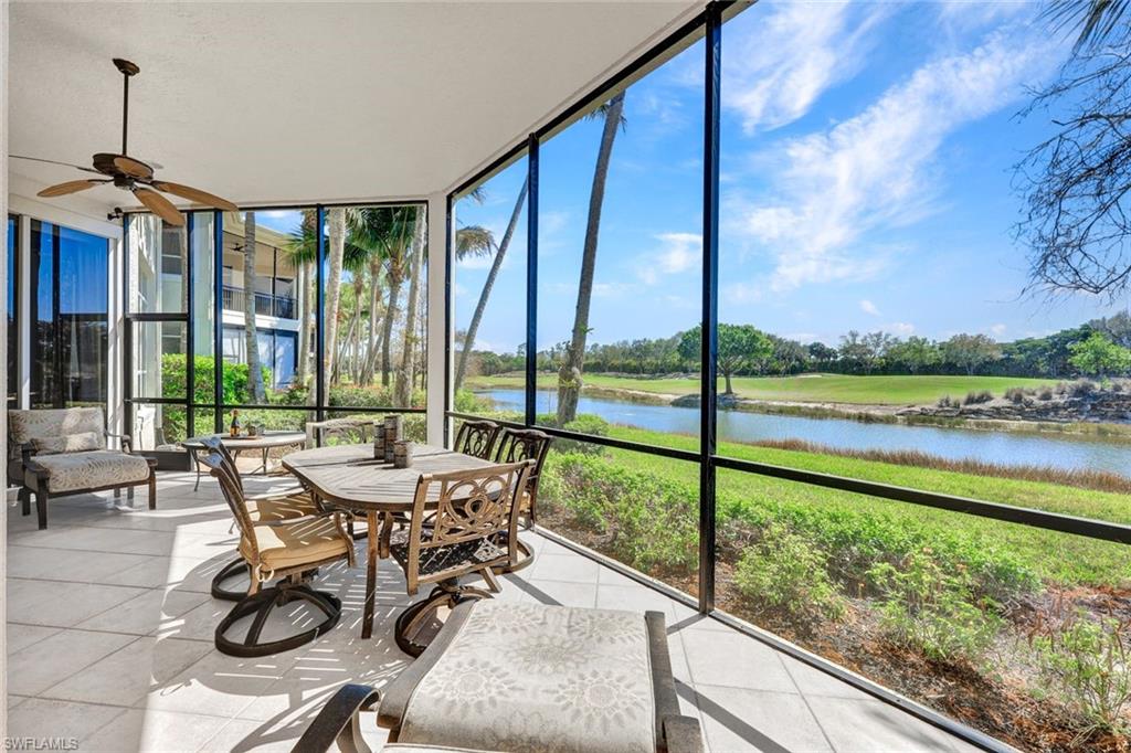 15516 Monterosso Lane, Unit 101 Naples, FL 34110 - Photo 24 of 31 Sunroom with ceiling fan, a water view, and outdoor dining area