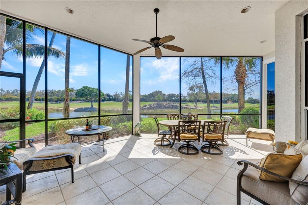 15516 Monterosso Lane, Unit 101 Naples, FL 34110 - Photo 25 of 31 Sunroom with floor to ceiling windows, a water view, tile patterned flooring, plenty of natural light, and golf course view