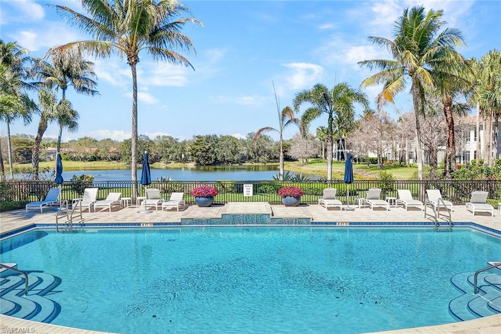 15516 Monterosso Lane, Unit 101 Naples, FL 34110 - Photo 27 of 31 Community pool featuring a patio area