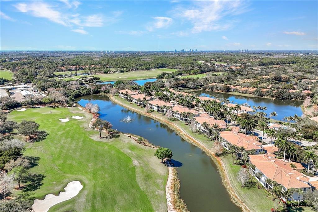 15516 Monterosso Lane, Unit 101 Naples, FL 34110 - Photo 28 of 31 Aerial perspective of suburban area featuring a large body of water and a golf course