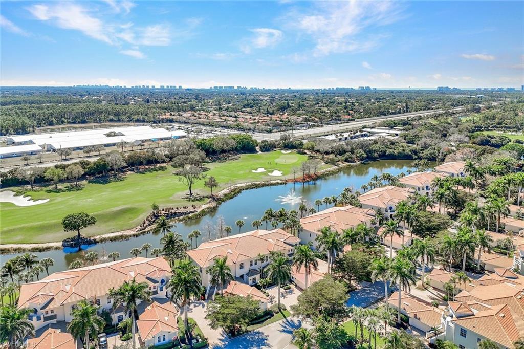 15516 Monterosso Lane, Unit 101 Naples, FL 34110 - Photo 29 of 31 Aerial perspective of suburban area with a large body of water and a golf club