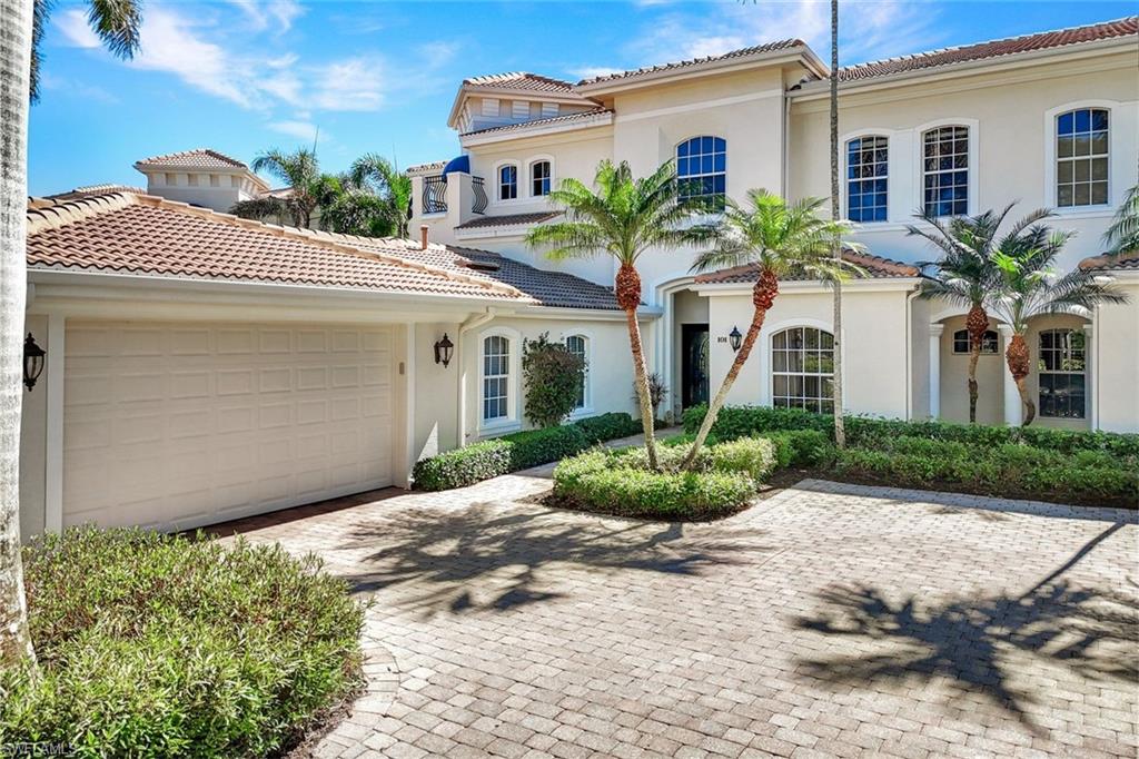 15516 Monterosso Lane, Unit 101 Naples, FL 34110 - Photo 3 of 31 Mediterranean / spanish house with stucco siding, decorative driveway, an attached garage, and a tiled roof