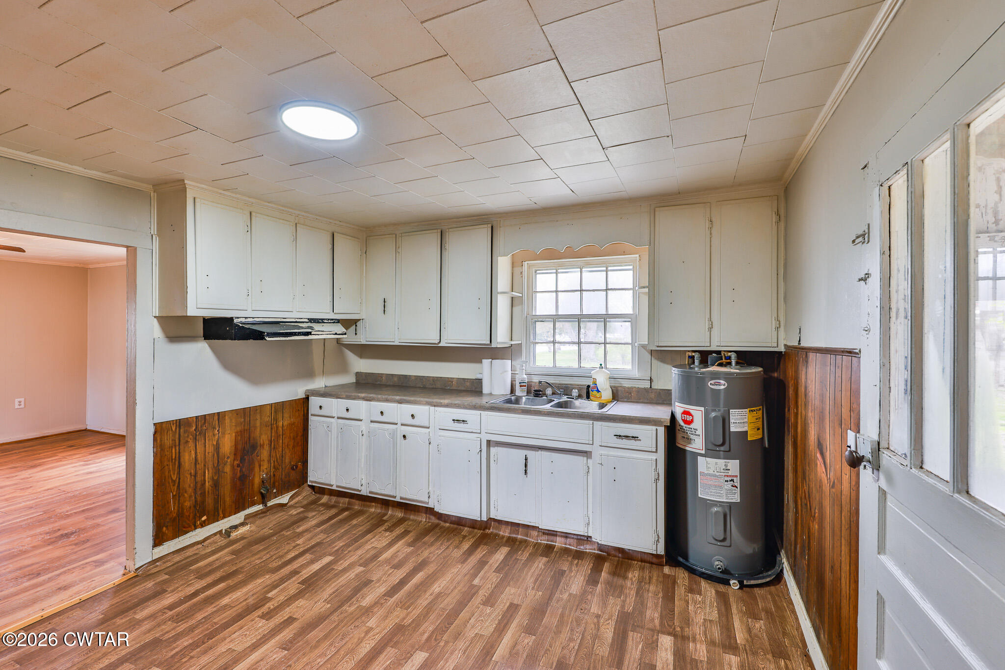 509 North Cedar Street Gleason, TN 38229 - Photo 11 of 26 a kitchen with a sink window and cabinets