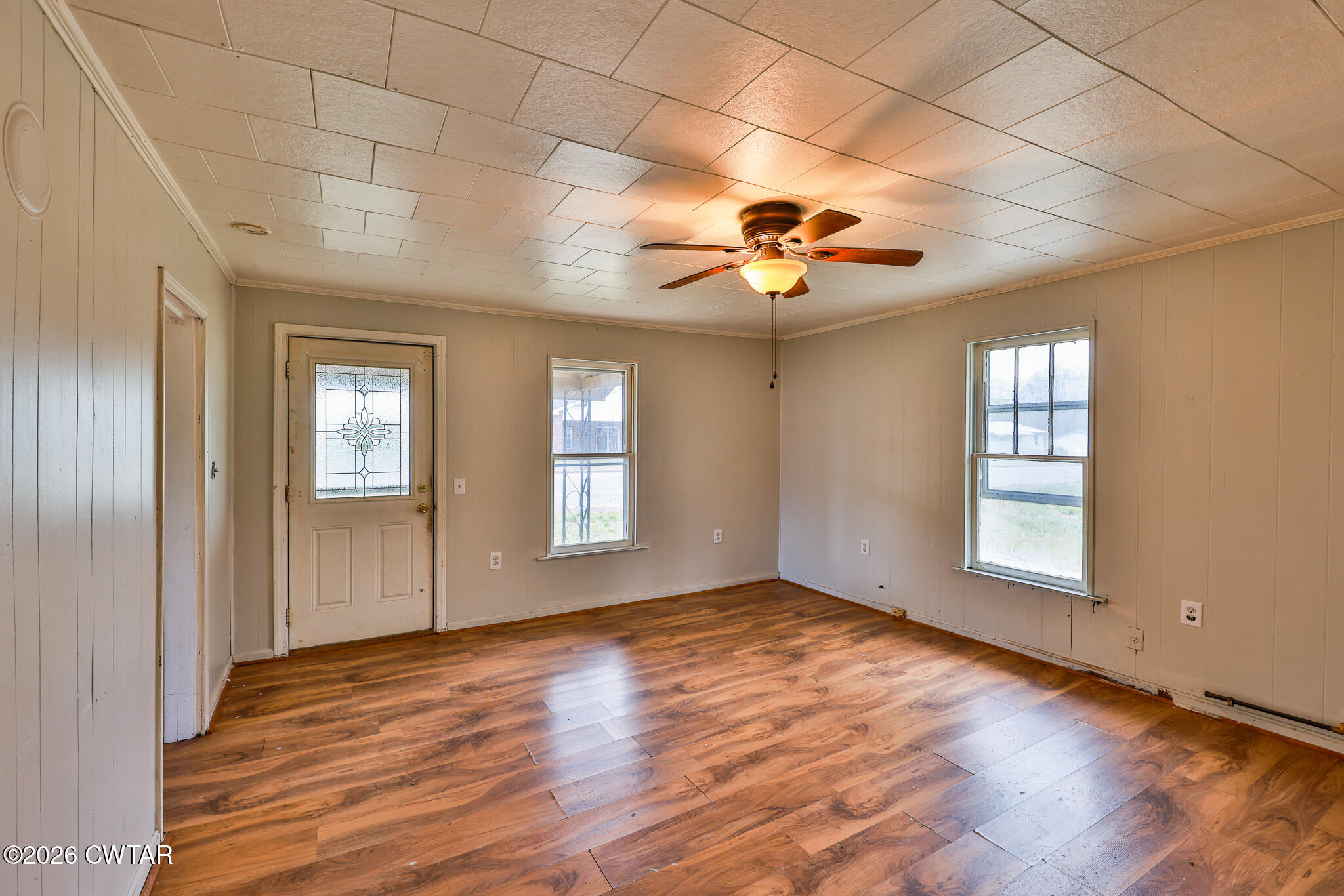 509 North Cedar Street Gleason, TN 38229 - Photo 3 of 26 a view of an empty room with a window and wooden floor