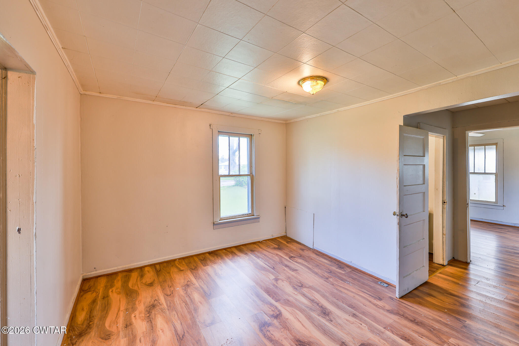 509 North Cedar Street Gleason, TN 38229 - Photo 7 of 26 an empty room with wooden floor and windows