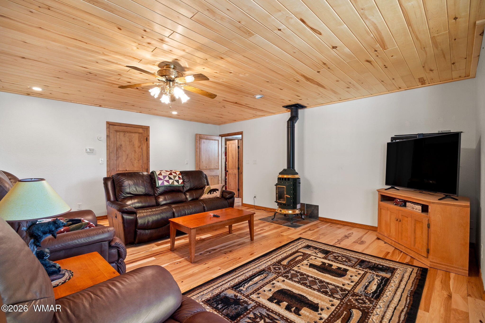 48 North 1068th Street Greer, AZ 85927 - Photo 17 of 37 a living room with furniture and a flat screen tv