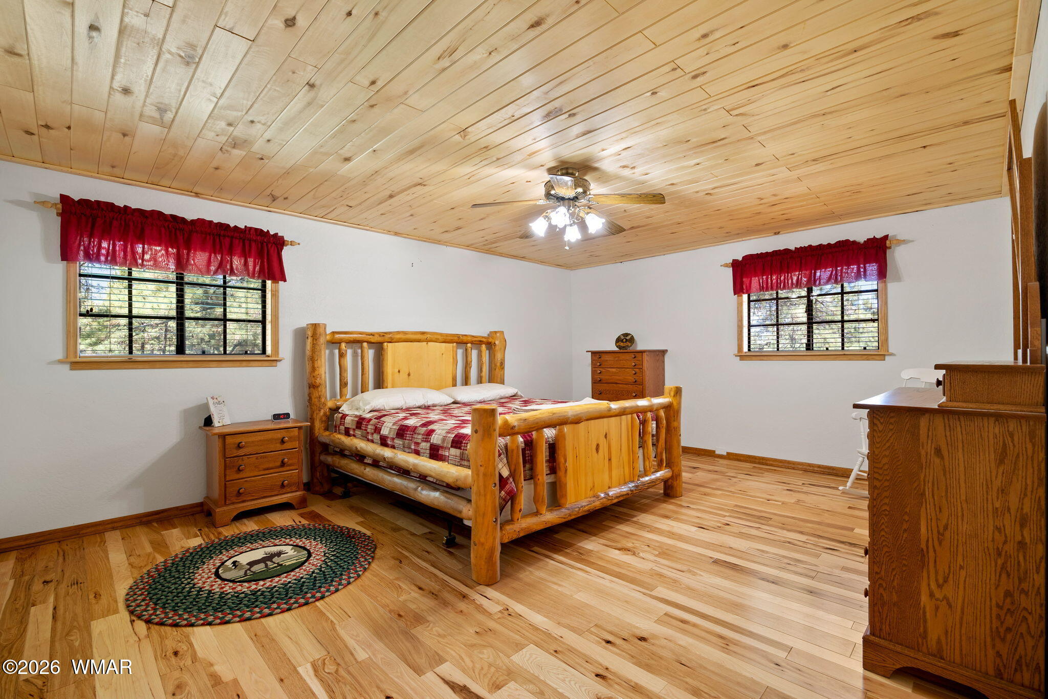 48 North 1068th Street Greer, AZ 85927 - Photo 18 of 37 a spacious bedroom with a bed and a chandelier