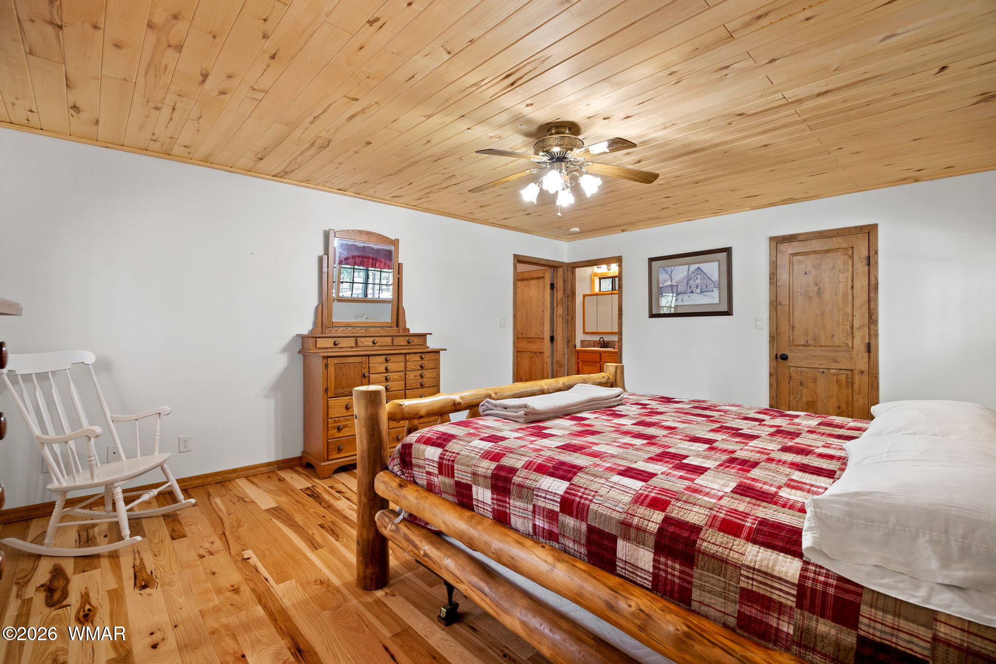 48 North 1068th Street Greer, AZ 85927 - Photo 19 of 37 a bedroom with a bed and wooden floor