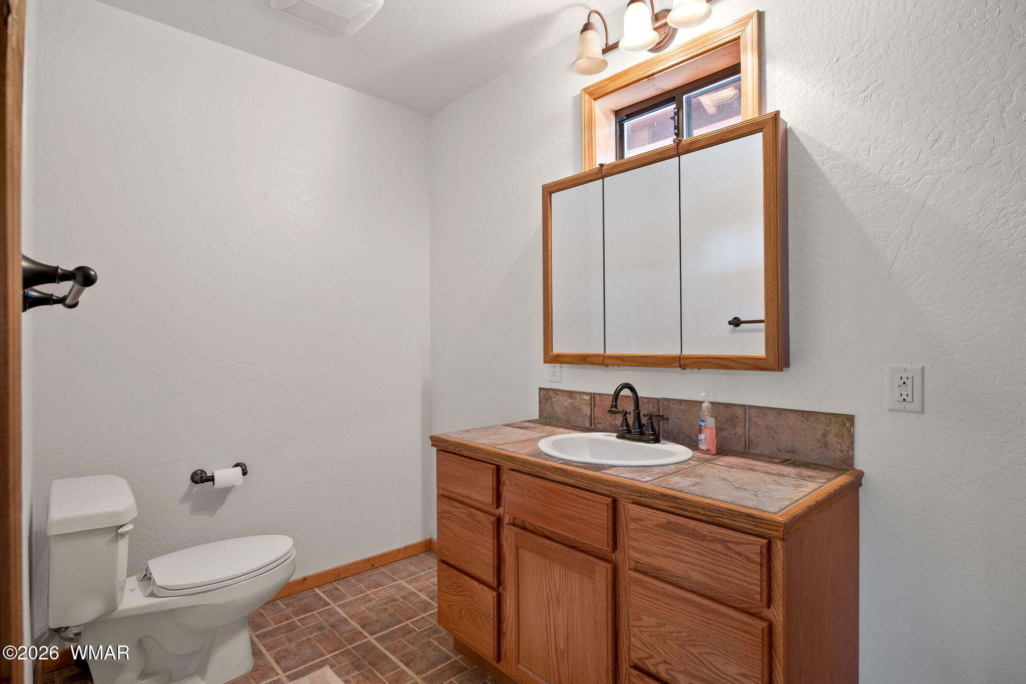 48 North 1068th Street Greer, AZ 85927 - Photo 20 of 37 a bathroom with a toilet sink and mirror