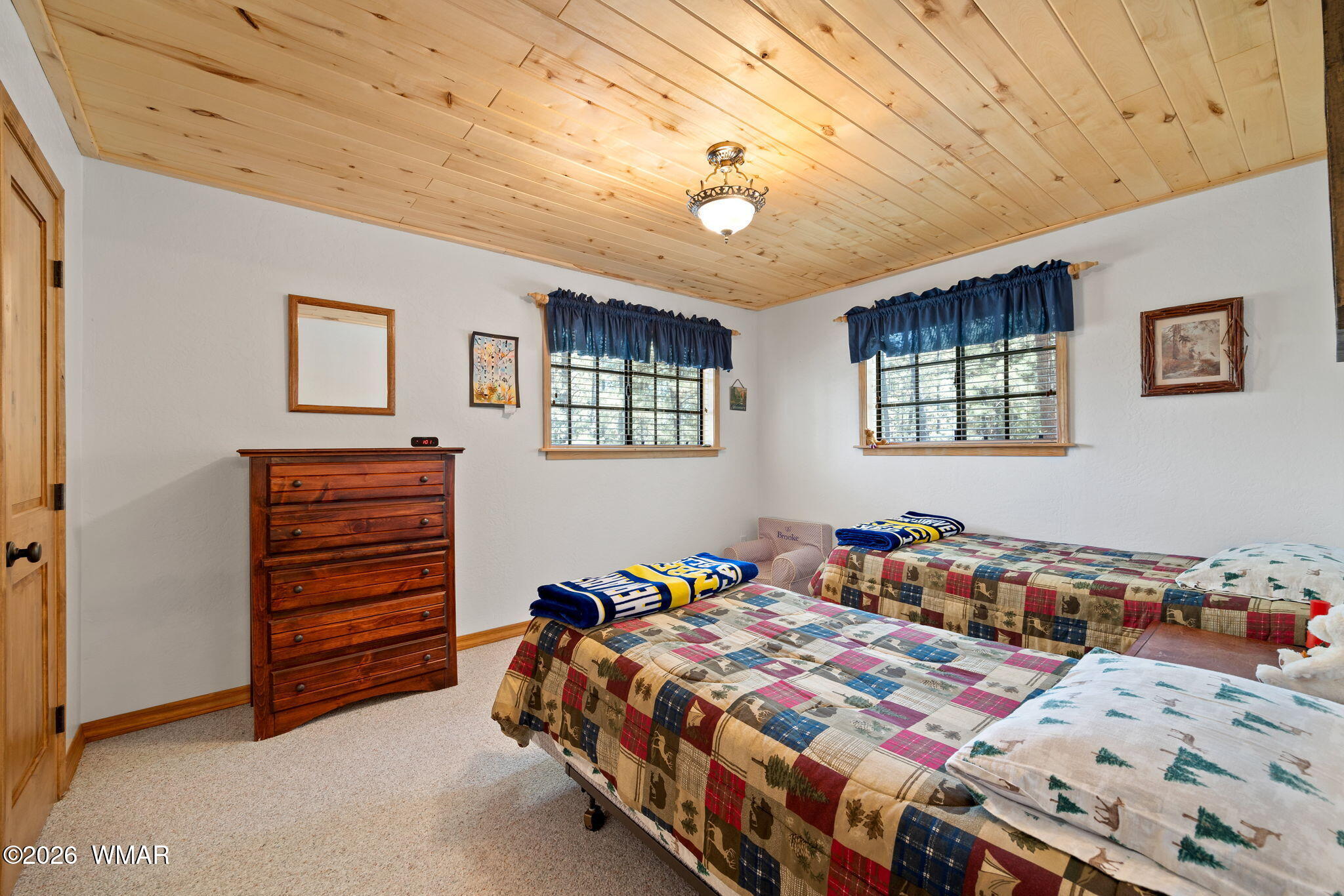 48 North 1068th Street Greer, AZ 85927 - Photo 24 of 37 a bedroom with a bed and a chandelier