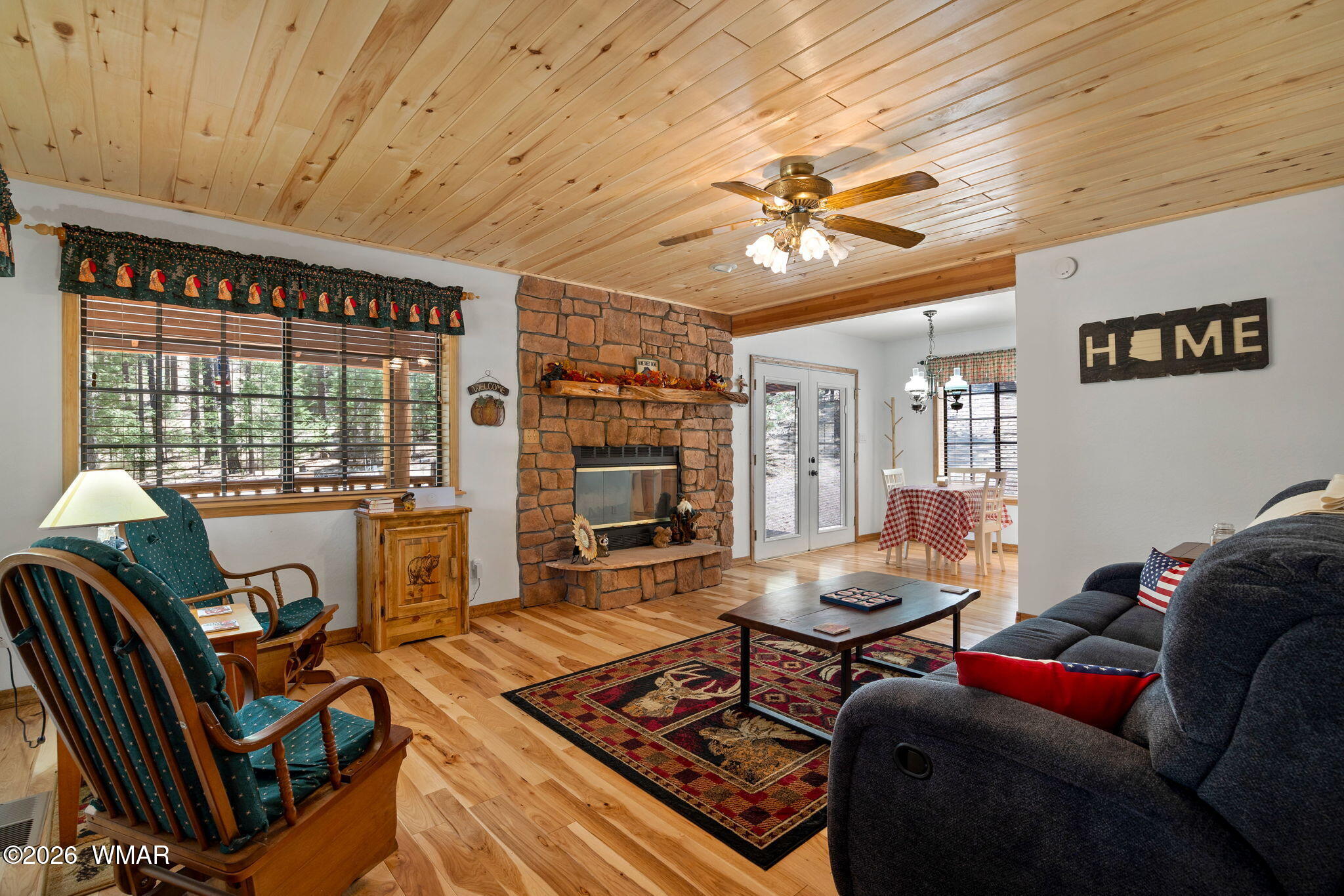 48 North 1068th Street Greer, AZ 85927 - Photo 6 of 37 a living room with furniture and a floor to ceiling window