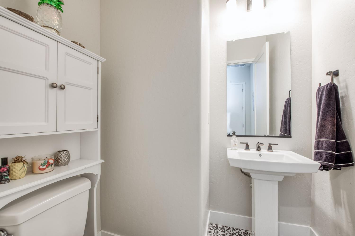 1020 Highland Road Madera, CA 93636 - Photo 16 of 42 a bathroom with a sink and a mirror