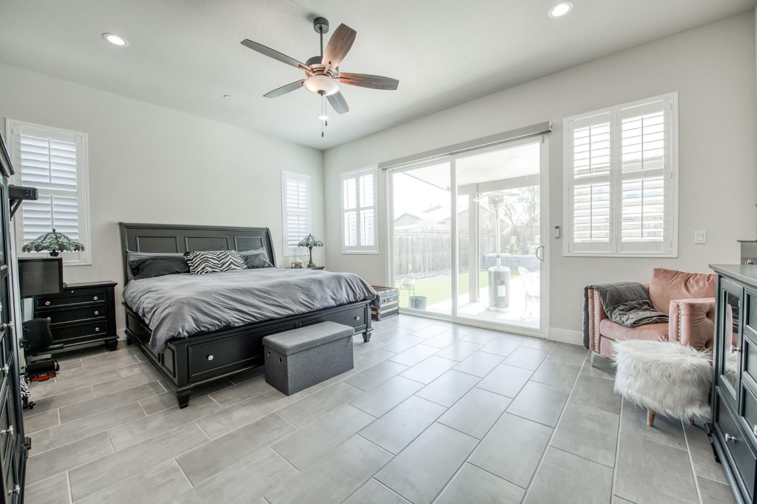1020 Highland Road Madera, CA 93636 - Photo 17 of 42 a spacious bedroom with a bed and a chandelier