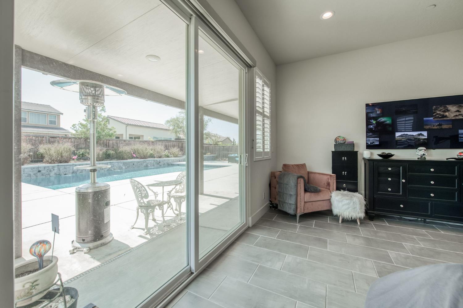 1020 Highland Road Madera, CA 93636 - Photo 18 of 42 a living room with furniture and a flat screen tv