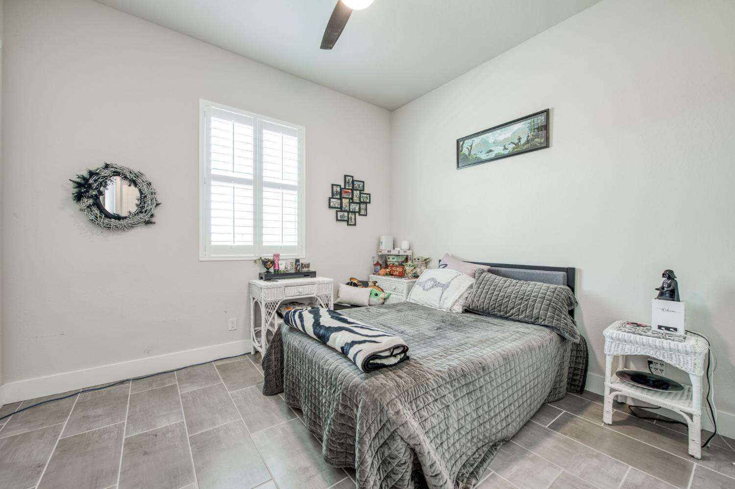 1020 Highland Road Madera, CA 93636 - Photo 21 of 42 a bedroom with a bed and a window