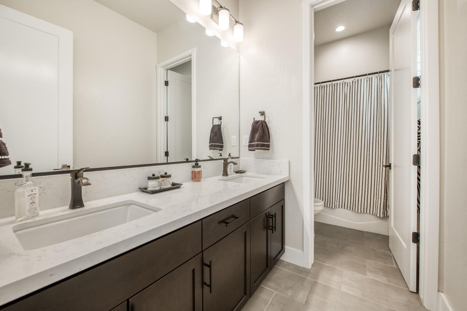 1020 Highland Road Madera, CA 93636 - Photo 24 of 42 a bathroom with a double vanity sink mirror and double