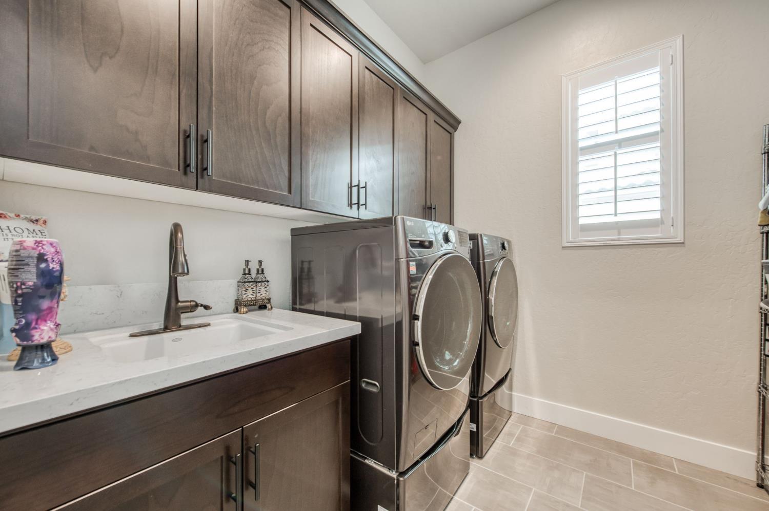 1020 Highland Road Madera, CA 93636 - Photo 25 of 42 a kitchen with a sink cabinets and washer