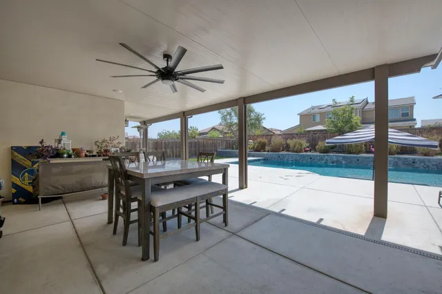 a view of a patio with couches and a table and chairs with wooden floor
