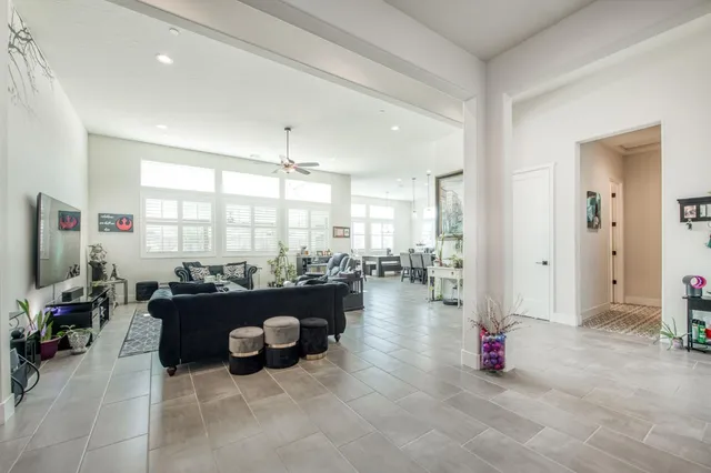 a living room with furniture and a chandelier