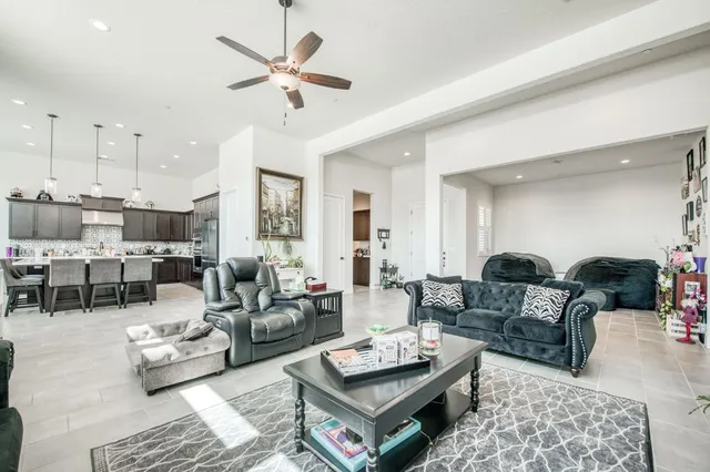 a living room with furniture ceiling fan and a rug